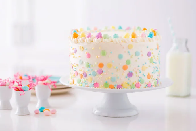 Break out the colorful sprinkles and candy eggs for this gorgeous Spring Lemon Cake–a perfect, and easy, Easter cake recipe! | Brit+Co