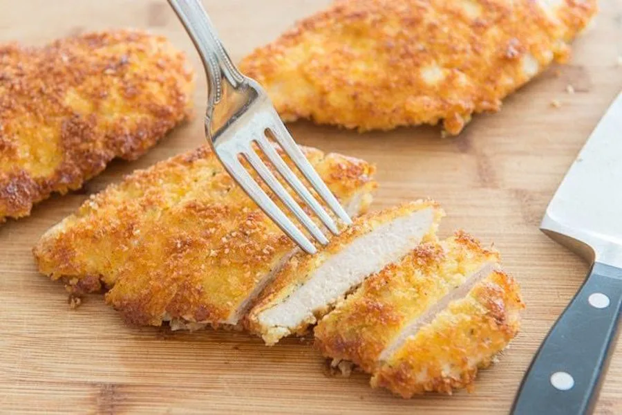 How to pound chicken: a quick tip that makes chicken cook more evenly and delicious, like in this Parmesan Crusted Chicken. | Fifteen Spatulas