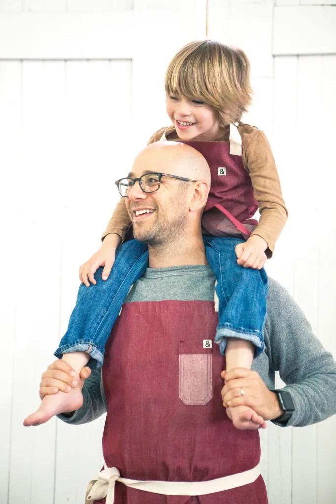 Gifts for dads who cook: A Daddy & Me apron set from Hedley & Bennet supporting PROJECT (RED