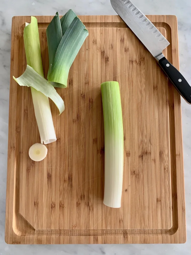 How to cook with leeks: snip off root and tough green tops. More tips on CoolMomEats.com | © Jane Sweeney How to cook with leeks: snip off root and tough green tops. More tips on CoolMomEats.com | © Jane Sweeney