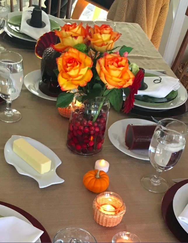 Eco-friendly table settings for Thanksgiving with cranberries and flowers