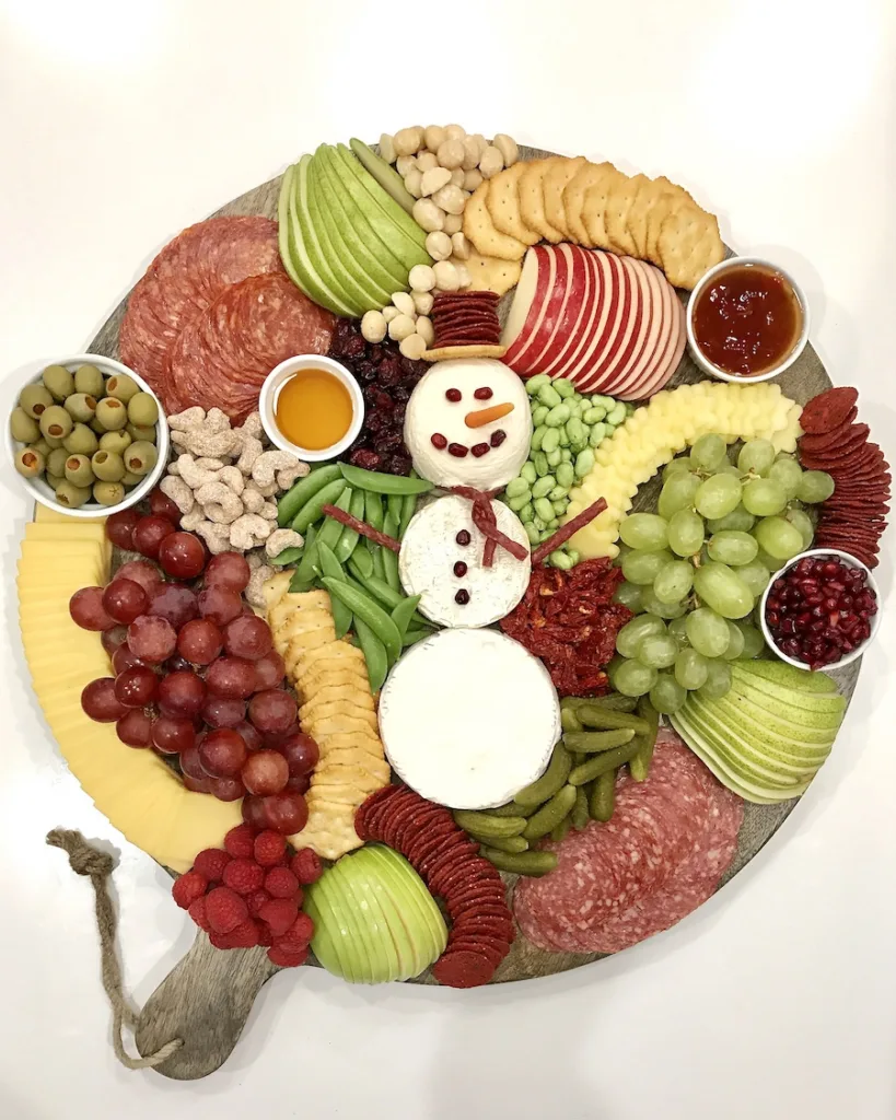 Surprise the kids with this Snowman Charcuterie snack board from The Baker Mama