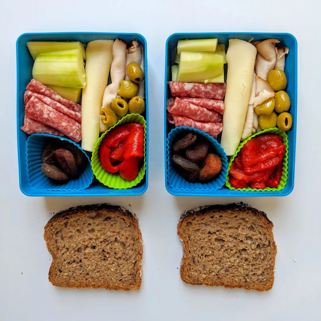 Nourished Not Famished uses cupcake liners to keep foods separated in this charcuterie style school lunch idea Nourished Not Famished uses cupcake liners to keep foods separated in this charcuterie style school lunch idea