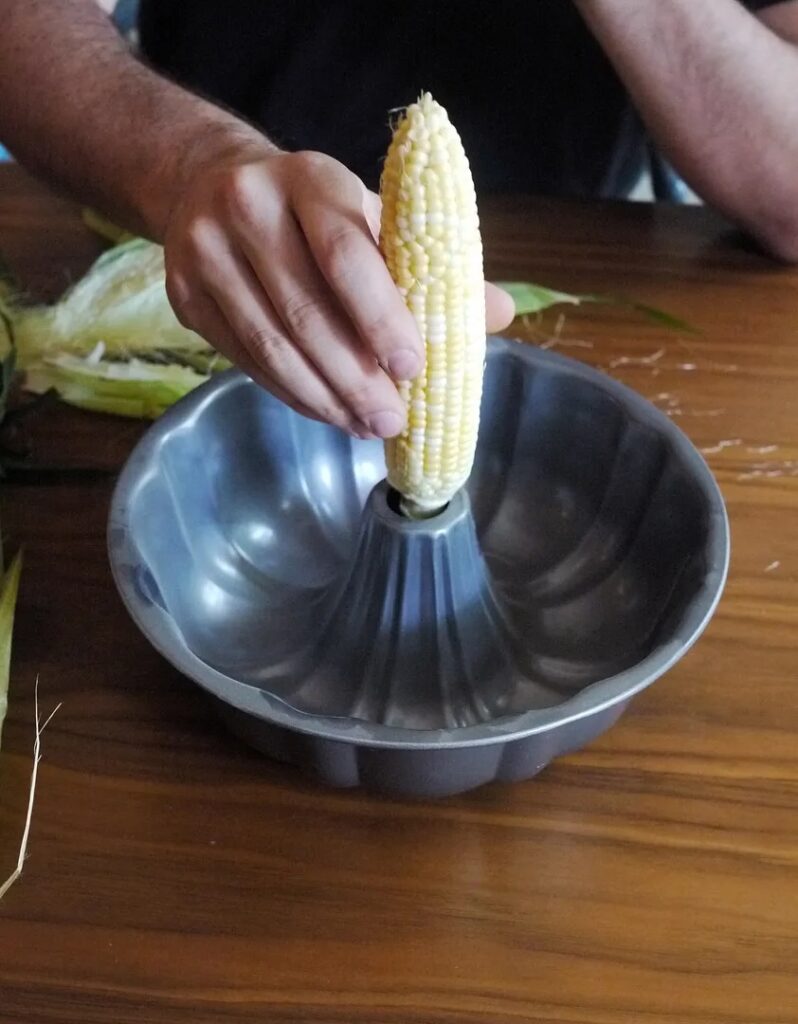 Balancing the corn cob in a bundt pan is the secret to our mess-free way to cut corn off the cob | Cool Mom Eats