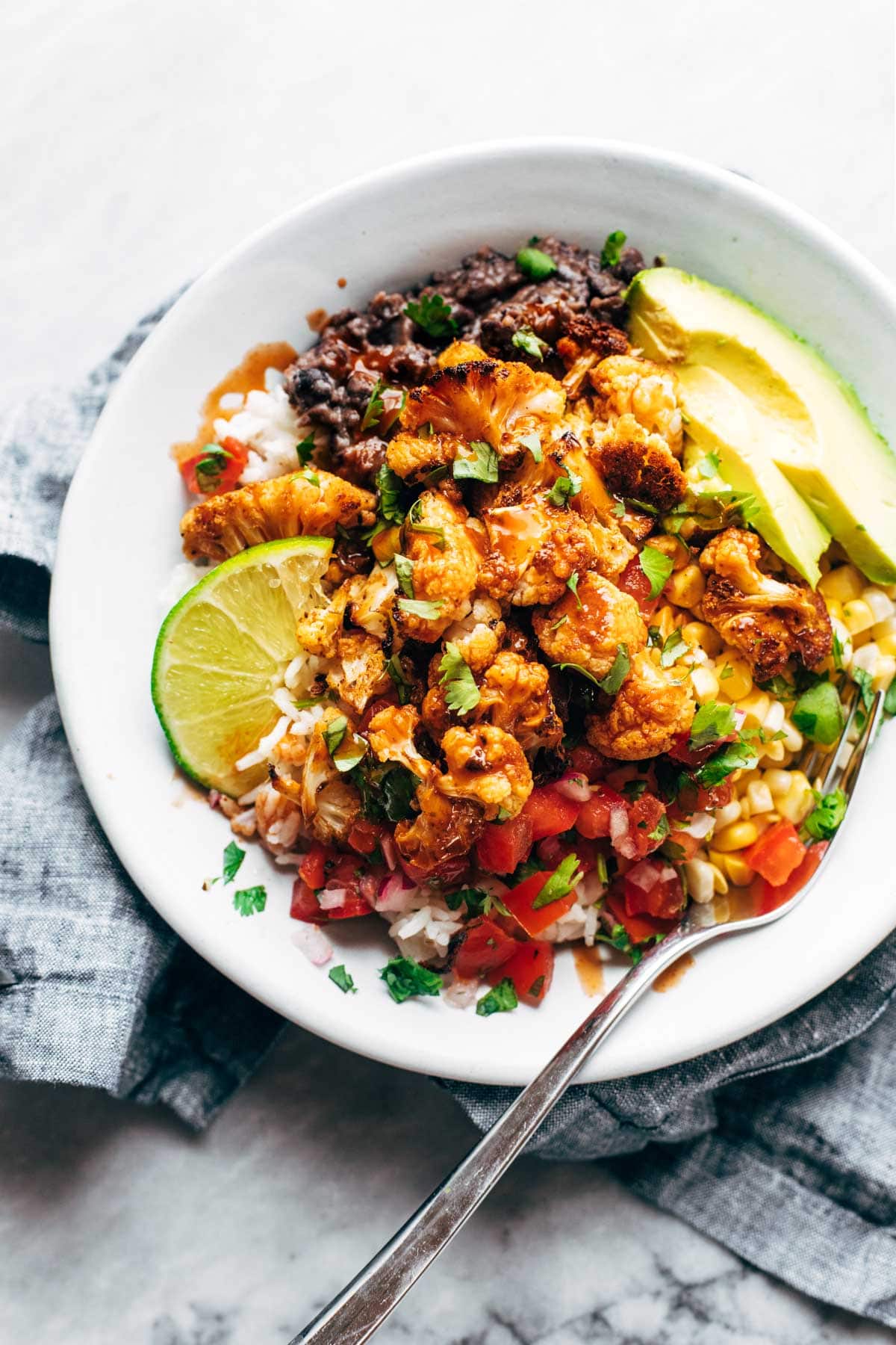 Lighter family dinner ideas for spring: Roasted cauliflower burrito bowls | Pinch of Yum