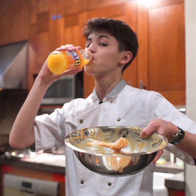 Teen chef Josh Reisner downs a Sunny D while he cooks