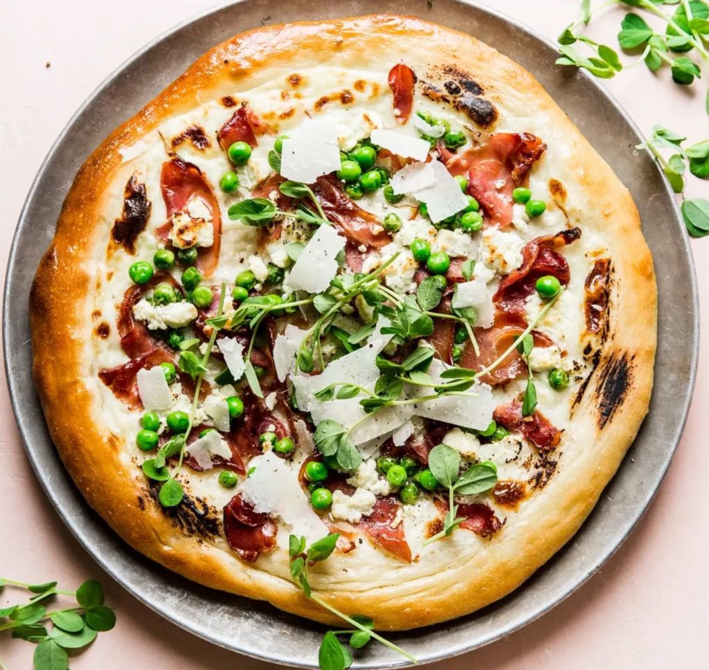 Pea and Prosciutto Pizza from The Modern Proper is a family favorite for DIY pizza nights at home