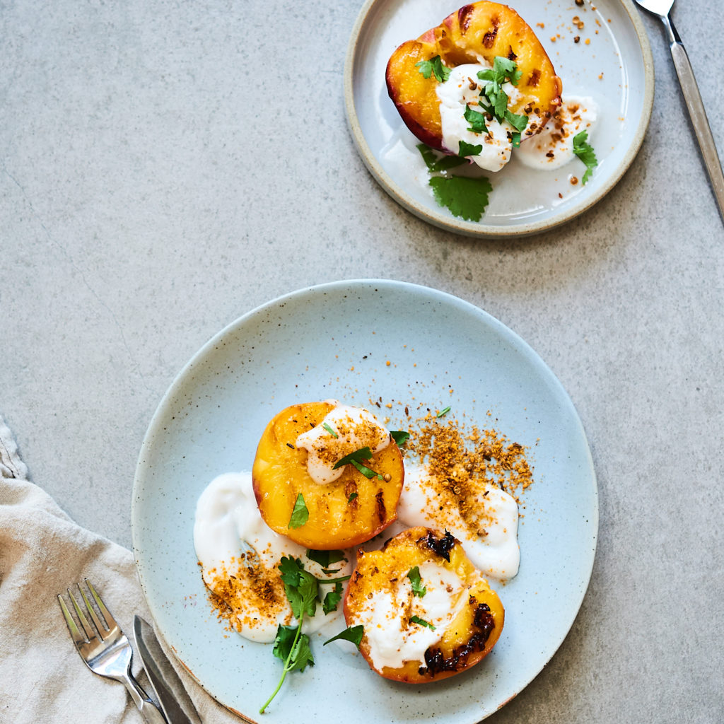 Tricks for lghter summer dessert recipes: Grill fruit instead of serving a regular fruit salad. These Grilled Peaches with yogurt at Living Kitchen Wellness
